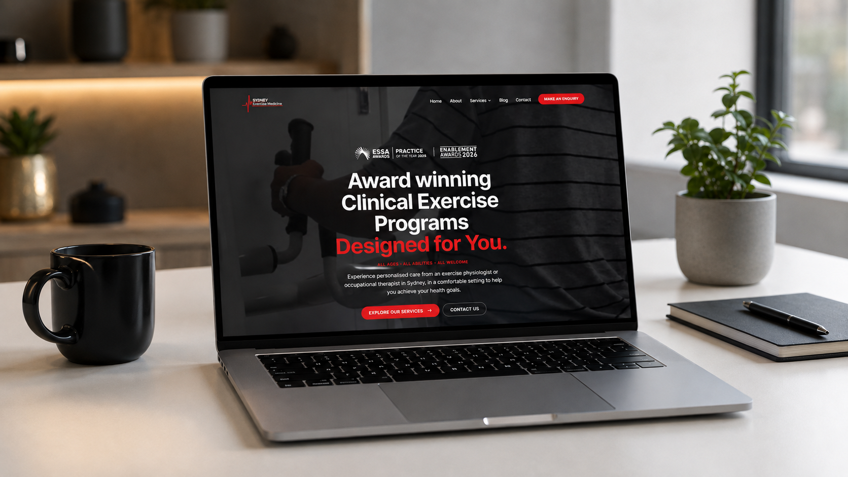 Sydney Exercise Medicine website displayed on a laptop, showcasing award-winning clinical exercise programs in a modern office setting.